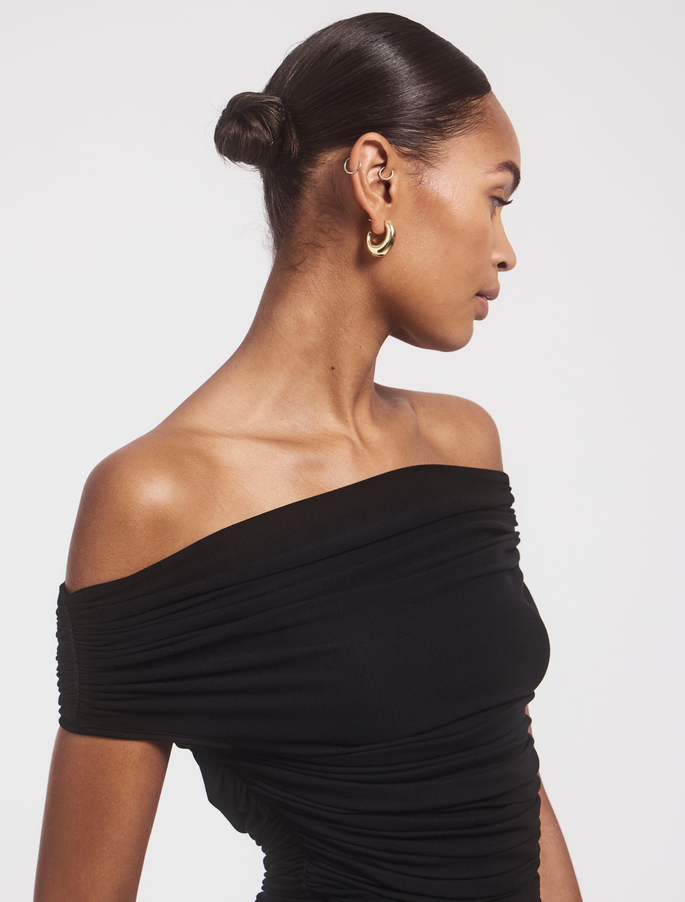 Side view of Noho Top in Black, off-shoulder design